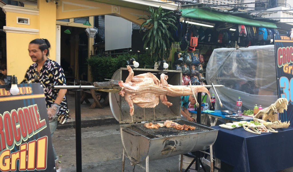 Street vendor selling crocodile meat on Khao San Road Bangkok, Thailand