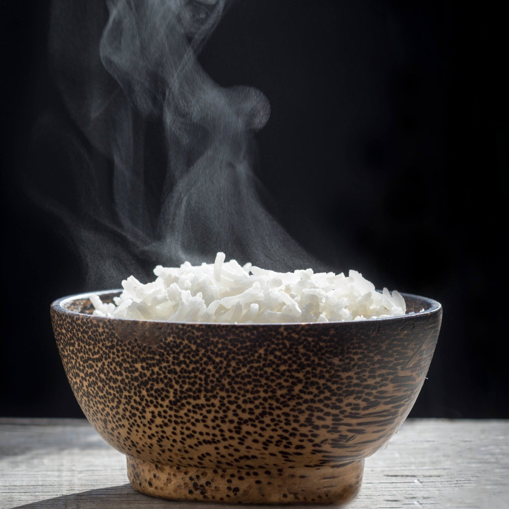 steaming Jasmine rice in wooden bowl